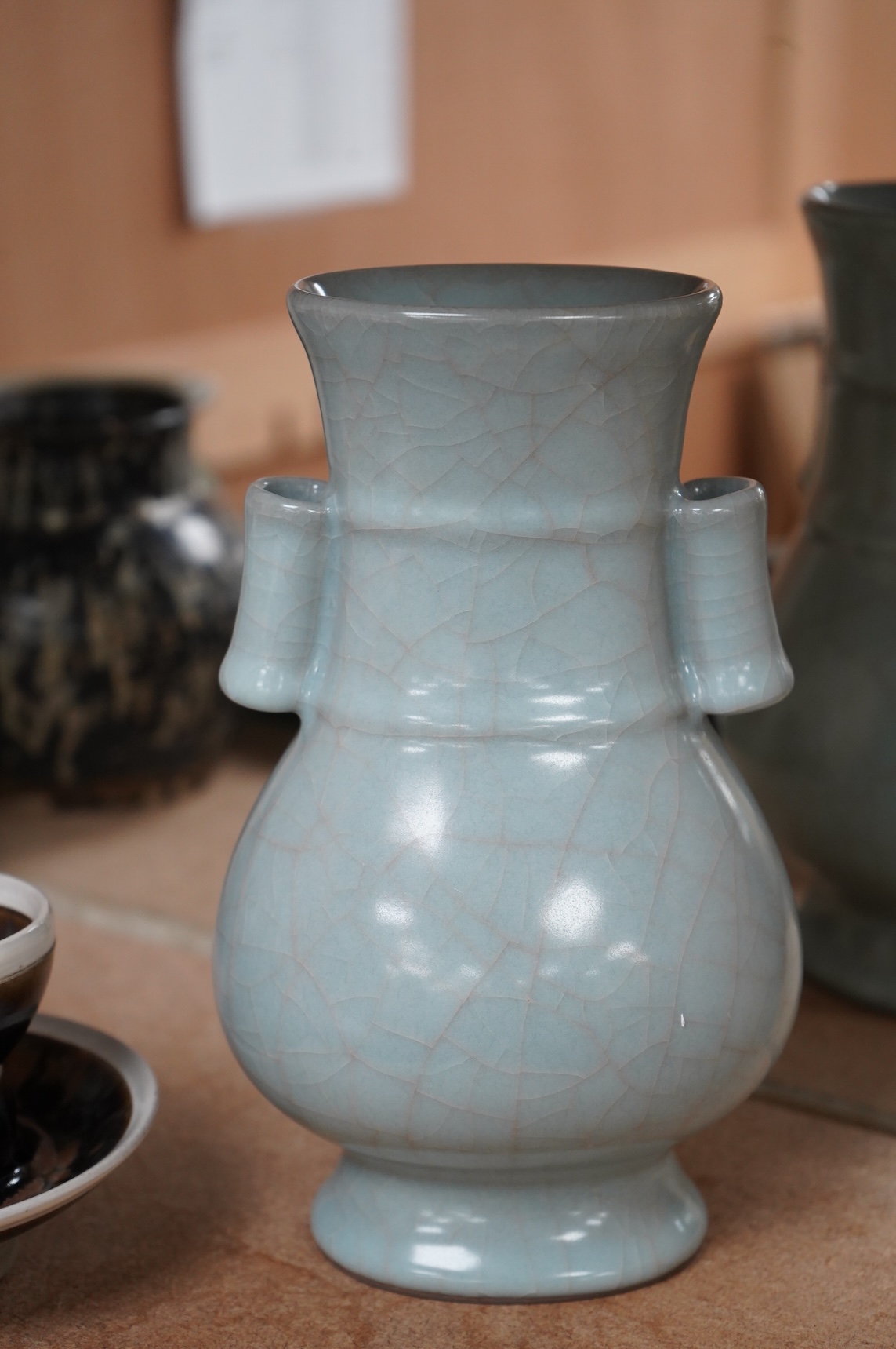 A Chinese crackle glaze arrow vase and a black and russet glazed tea bowl on stand, largest 22cm high